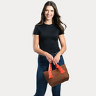 Women holding chocolate liberty woven neoprene tote at the handles