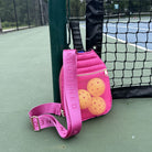 Poppy Quilted Nylon Pickleball Paddle Bag in Pink on pickleball court