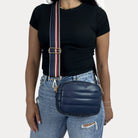 women wearing the Sadie Quilted Vegan Leather Crossbody in Navy with a Striped Bag Strap