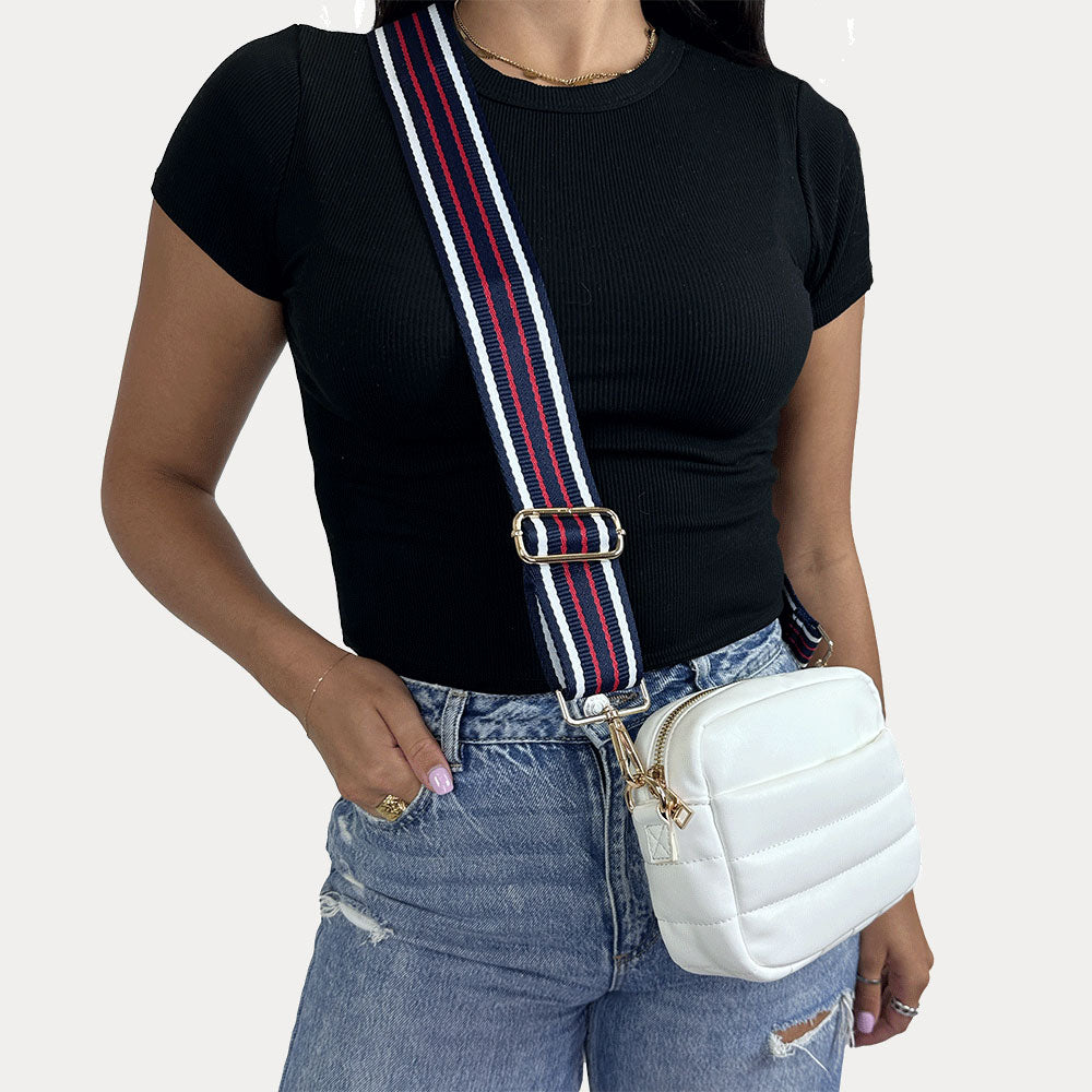 women wearing the Sadie Quilted Vegan Leather Crossbody in White with a Navy-Red-White Striped Bag Strap