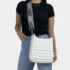 women wearing the Sarah Quilted Vegan Leather Messenger in Cream with a Geometric Patterned Bag Strap