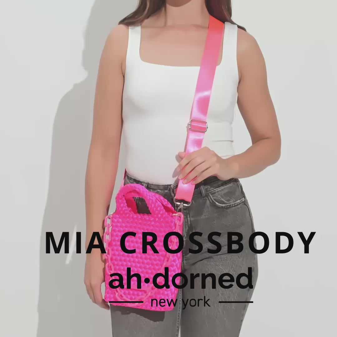 Woman walking around with the Mia woven satin bag.  